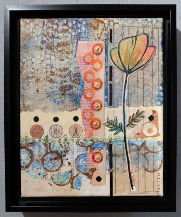 Mixed media collage in black floater frame.